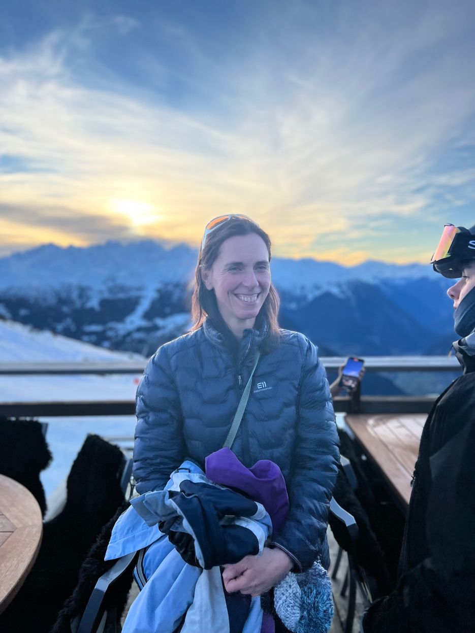 Sarah, expat integration specialist, with the Valais Alps at sunset, Val des Bagnes