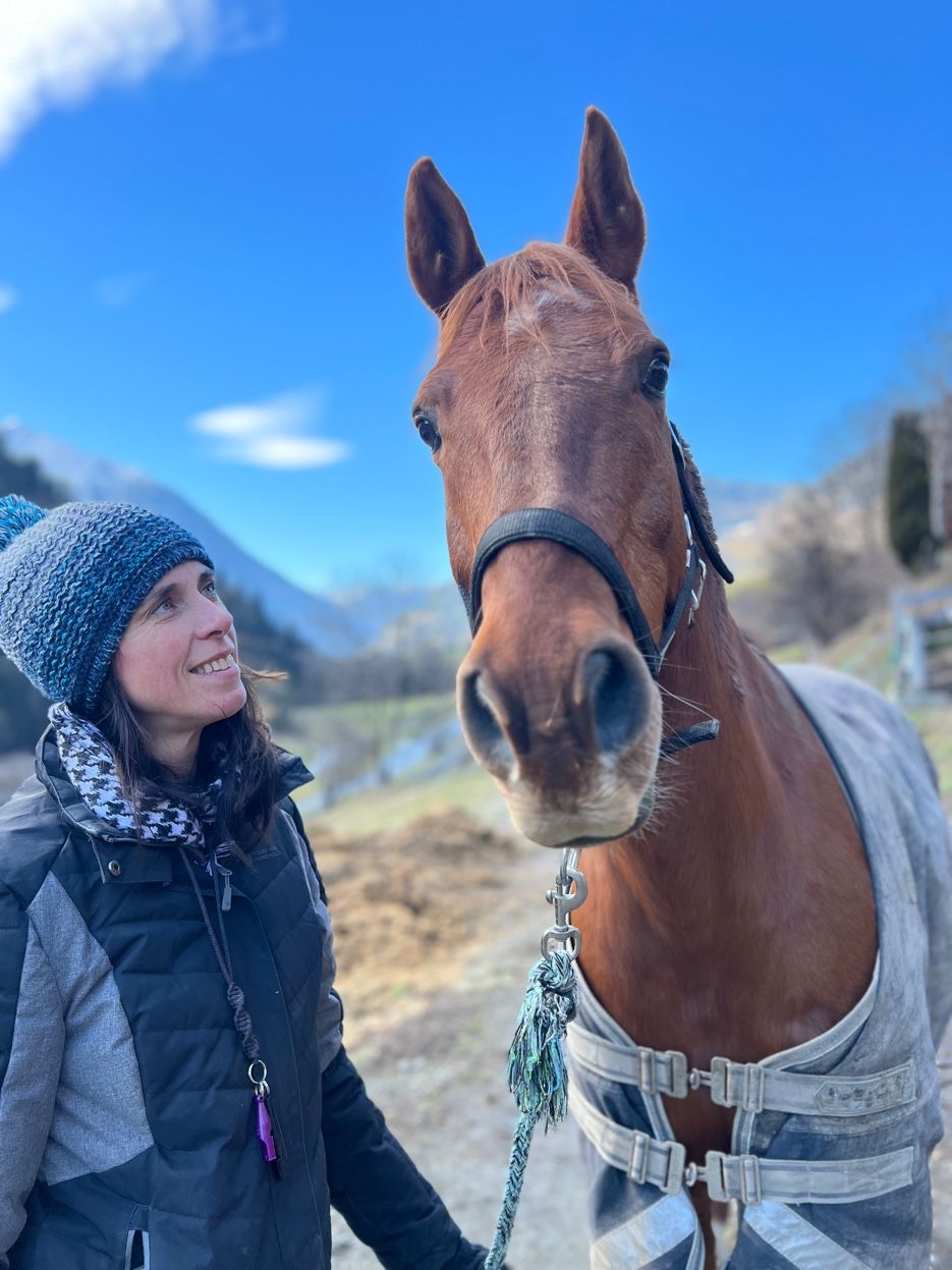 Sarah with her horse in Val des Bagnes valley — Valais relocation expert